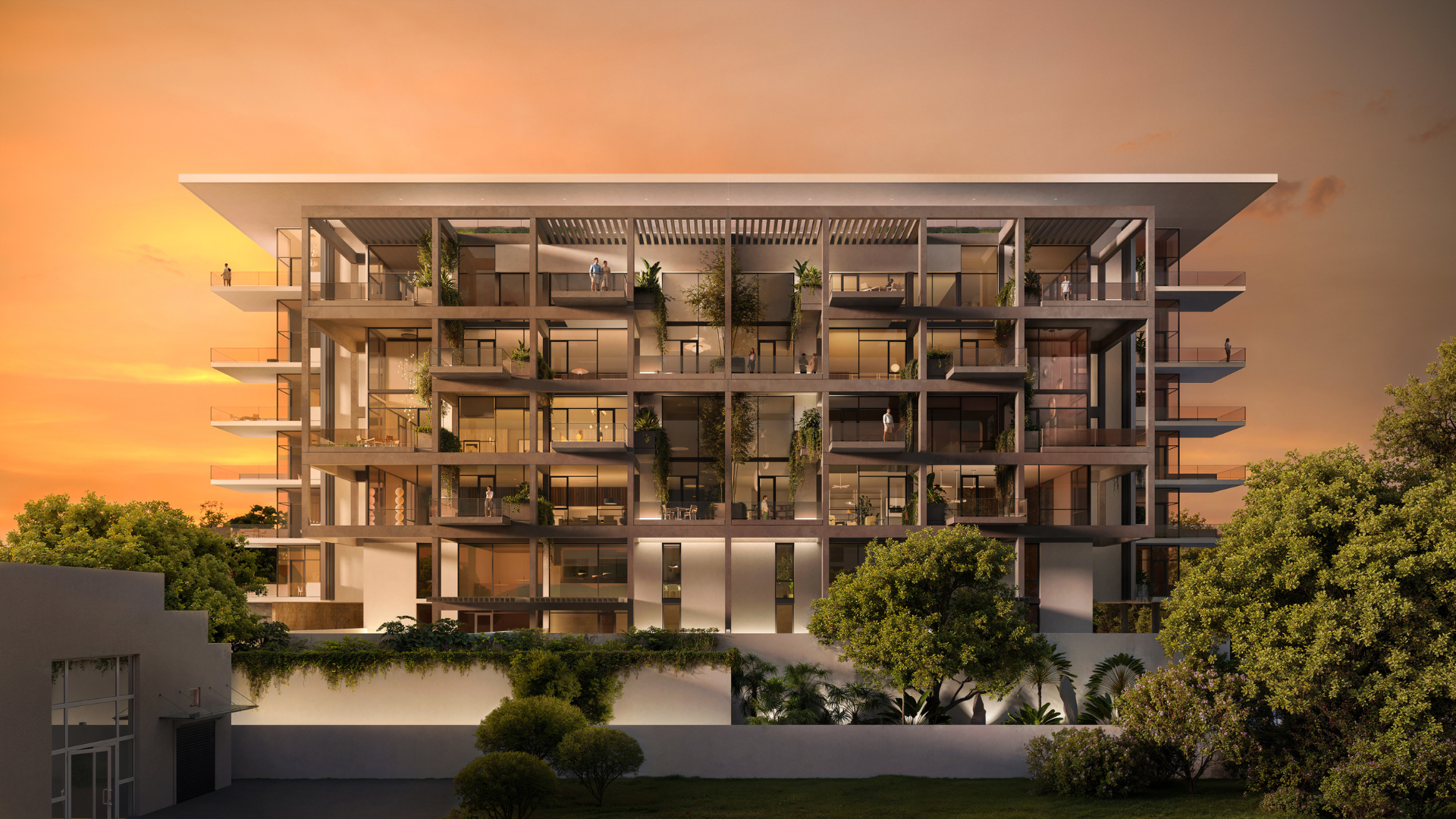 Modern multi-story apartment building with glass balconies, plants, and warm lighting at sunset, surrounded by lush greenery and trees, with people visible on balconies and rooftops.