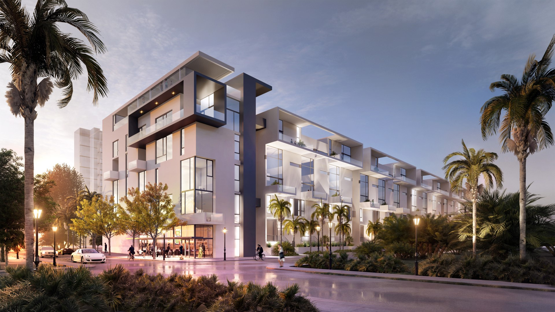 Modern multi-story apartment building with geometric balconies, large windows, palm trees, street lamps, cars, and people outside, all illuminated by soft evening light.